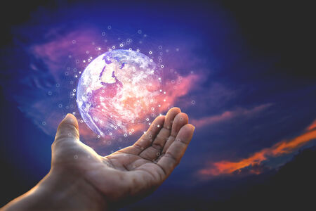 Hand cupped with a hologram of the globe hovering above