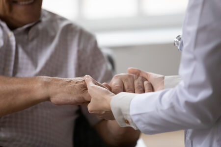 Social Worker holding hands with a client